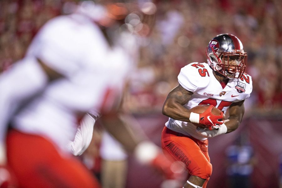 Western Kentucky Hilltoppers running back Joshua Samuel (25) is handed the ball in the first quarter during the NCAA football game between the Western Kentucky Hilltoppers and Wisconsin Badgers at Camp Randall Stadium on August 31. 