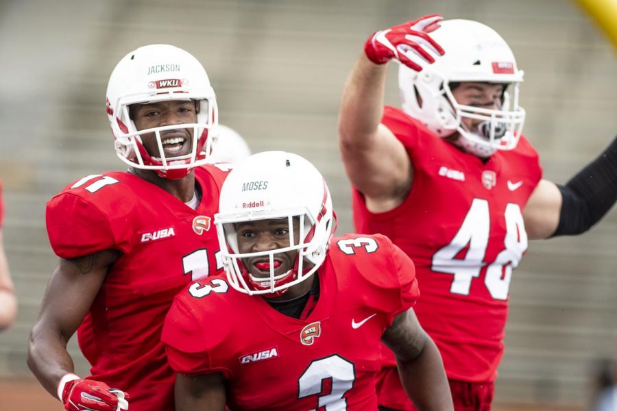 WKU running back Jakairi Moses (3) celebrates his touchdown in the first quarter with wide receiver Lucky Jackson (11) and tight end Steven Witchoskey (48) during the Red vs White Spring game on April 13. The Red team came up short to the White team, losing 28-21. CHRIS KOHLEY/HERALD