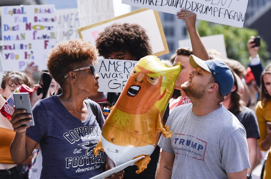 Codi Schneider, a supporter of President Trump, speaks with protesters in the crowd outside the Galt House during the AMVETS 75th Annual Convention in Louisville on Wednesday, Aug. 21, 2019. Schneider said he was glad to have someone in office who wasnt a politician, even though he doesnt always like what Trump says.