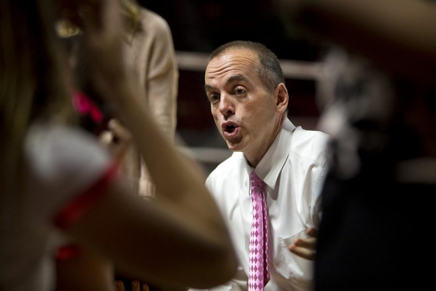 Head coach Travis Hudson speaks to his team during a timeout in the Lady Toppers matchup against Texas-El Paso. 