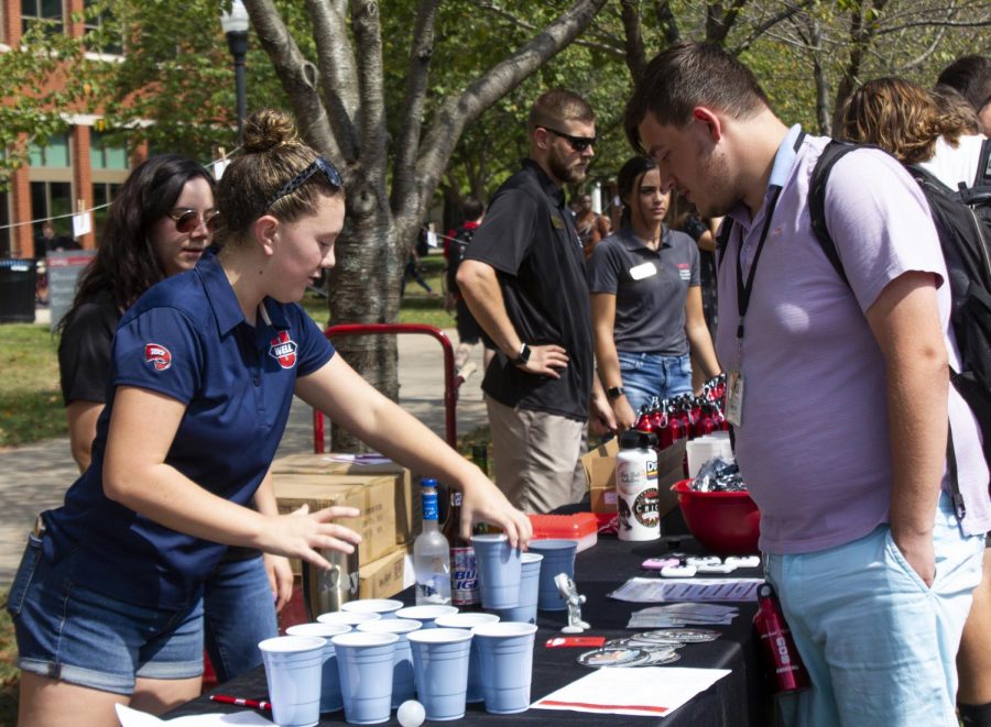 Senior Avery Nordgren of WKU Health Education and Promotion teaches the alcohol intake of different drinks to Freshman Simon Confederat by quizzing Confederat on which beverages have the highest percentage of alcohol. Confederat played water pong to win prizes. “(Stay safe WKU) changed my view with how to look at drinks… mixing things together gives you a higher alcohol intake than by itself,” Confedrat said.