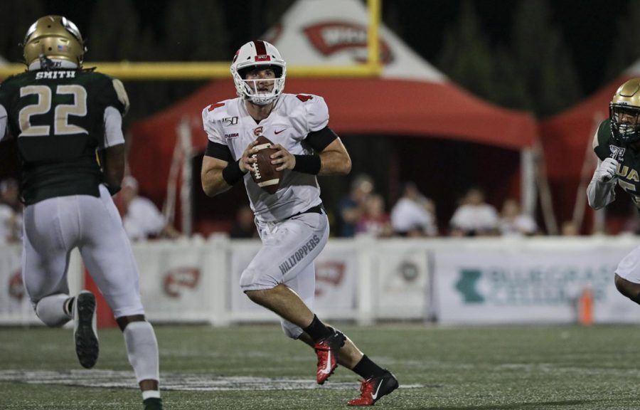WKU quarterback Ty Storey (4) runs downfield with the ball against UAB at Houchens-Smith Stadium. Storey rushed for 26 yards during the game.