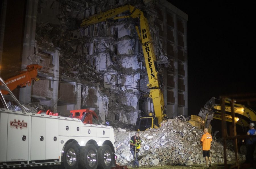 A demolition crew hired by Western Kentucky University work overtime to pull their long-armed excavator out of an unknown crawlspace at the demolition site of Bemis Hall late Friday evening, Sep. 10, 2019.
