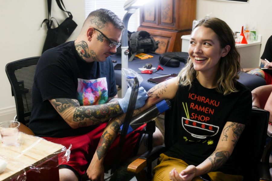 Jonathan Fowler tattoos Abby Schuster, a WKU alumna. Schuster began getting tattooed by Fowler while attending Western. “We drove all the way from Cincinnati to see Jonathan,” said Schuster.