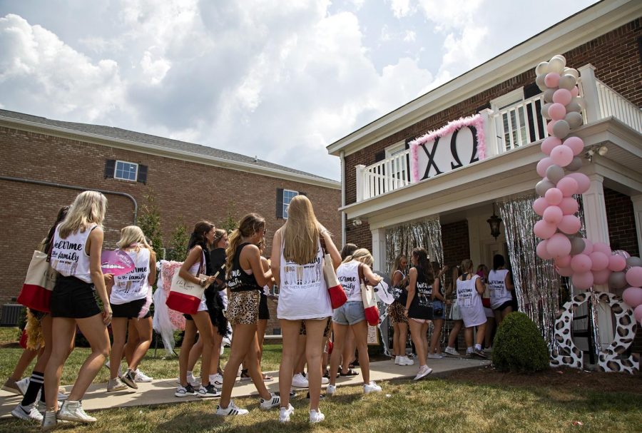 Active members and new members of Chi Omega file into the chapter house to celebrate bid day on Tuesday, Aug. 20, 2019.