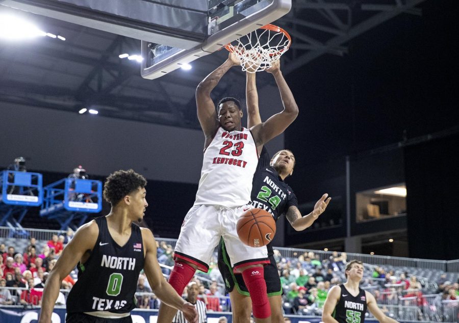 WKU freshman center Charles Bassey (23) slams home a dunk over North Texas Zachary Thomas (24) in day two of the C-USA Tournament at the Ford Center at The Star march 14 in Frisco, Texas. Bassey accumulated 9 points, 8 rebounds and 4 blocks in the 67-51 Hilltopper victory. 