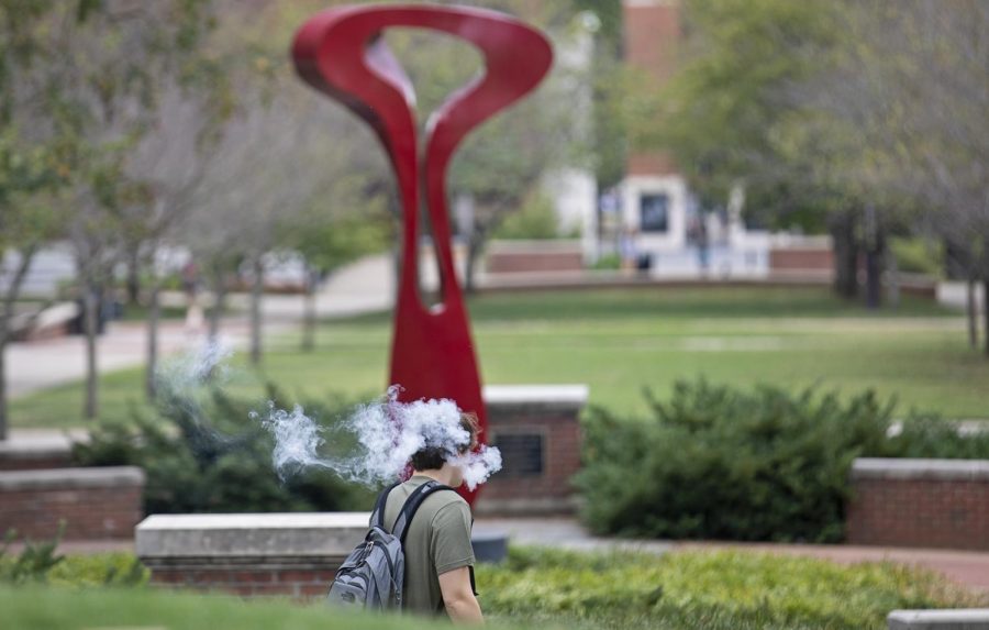A student walks through Centennial Mall exhaling smoke from a non-THC vape pen on Monday, Sept. 23, 2019. Seven people in six states have died recently due to e-cigarette related pulmonary illnesses.