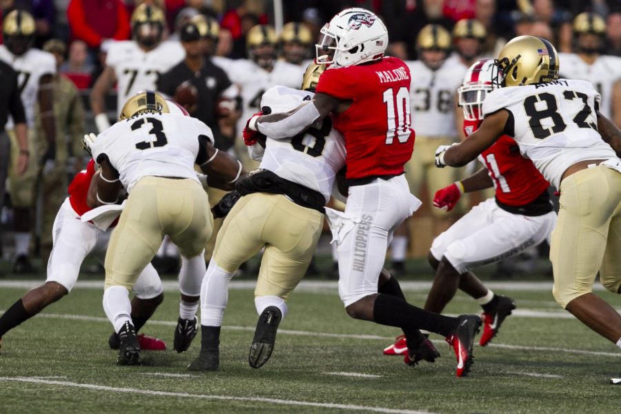 WKU defensive end DeAngelo Malone (10) tackles Army quarterback Kelvin Hopkins Jr. after a gain of 5 yards on Armys 33 yard line. The Hilltoppers defeated the Black knights 17-8 at Houchens-Smith Stadium on October 12, 2019.