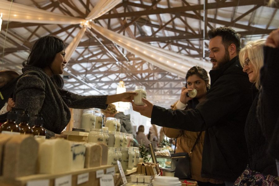 Grace Kosch (left), owner of Whānau Inspired, offers “free smells” to all who come across her booth during the weekend GypsyMoon Marketplace Christmas event. The marketplace featured vendors, live music and visits with Santa Claus.