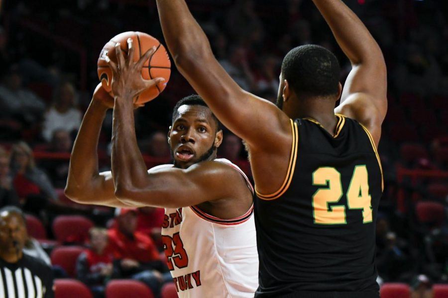 WKU+sophomore+center+Charles+Bassey+%2823%29+looks+for+a+pass+option+during+the+exhibition+basketball+game+between+Kentucky+State+and+WKU+in+Diddle+Arena+on+November+2%2C+2019.+WKU+won+85-45.