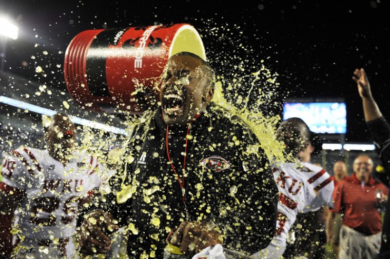 WKU head coach Willie Taggart is doused with the powerade bucket after WKUs win over the University of Kentucky. WKU won over UK in overtime with a final score of 32-31 at Commonwealth Stadium in Lexington on Sep. 15, 2012.
