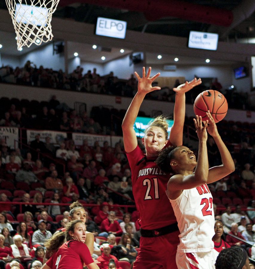 Lady topper sophomore Sherry Porter (25) attempts to shoot for two as she defended by Louisville forward Junior Kylee Shook (21) during the Lady Toppers 102-80 loss in the first USA conference game against Louisville University on Tuesday Nov, 6, at the E.A. Diddle Arena.