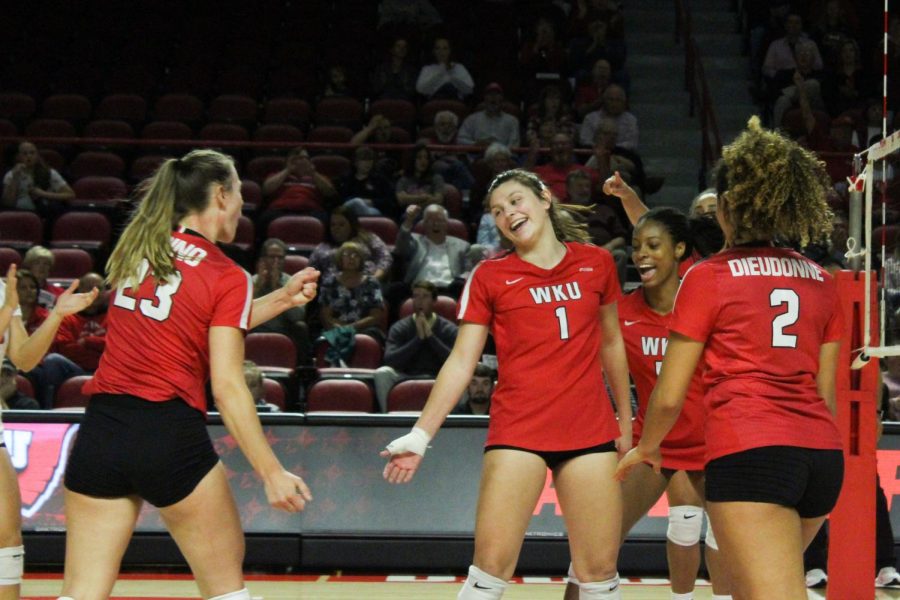 The Lady Toppers celebrate a point scored by freshman Paige Briggs (1) during Sunday’s game in Diddle Arena. Briggs had a total of 10 kills, five blocks, five digs, one ace and ended the game with a .320 hitting percentage.