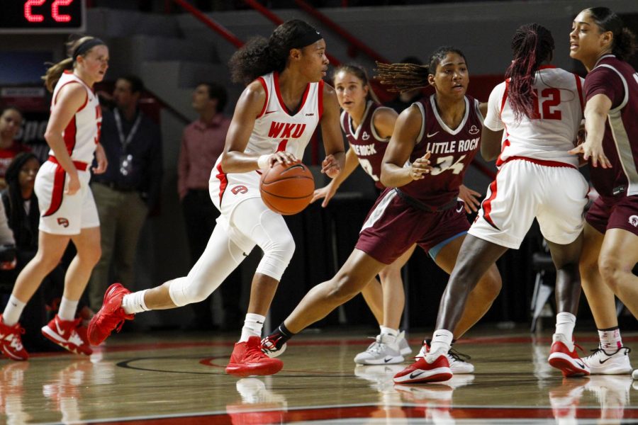 WKU foward Dee Givens (4) use the screen from Fatou Pouye (12) to dribble toward the top of the key. The Lady Hilltoppers defeated Little Rock 77-58 on November 24, 2019 at E.A. Diddle Arena.