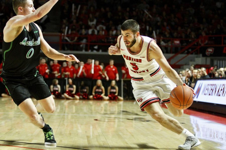 Graduate+guard+Camron+Justice+%285%29+drives+inside+on+Marshall+redshirt+freshman+guard+Andrew+Taylor+%280%29+during+the%C2%A0WKU+Hilltoppers+91-84+win+over+the+Marshall+Thundering+Herd+on+Saturday%2C+Jan.+25+in+Diddle+Arena.