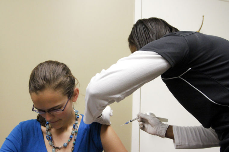 Bowling Green graduate student Emily Burns prepares to get a flu shot from nurse Chandra Ellis-Griffith at the academic complex on Jan. 30. Free flu shots were offered in the academic complex by the WKU Institute for Rural Health.