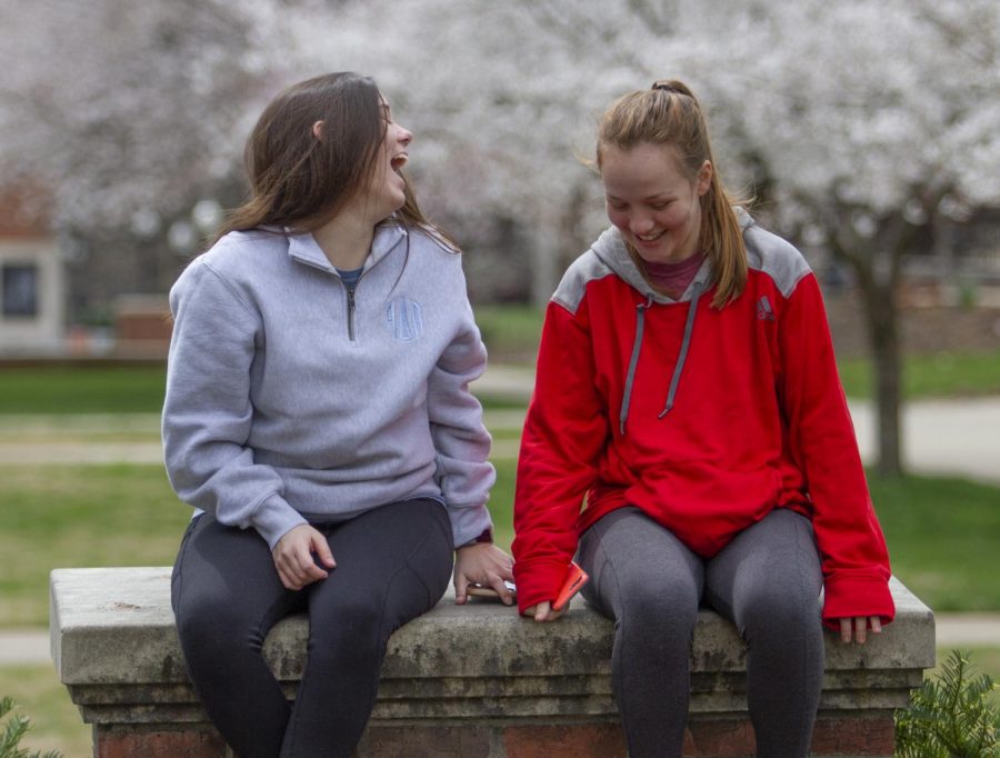 Gabrielle Sledge (left), a health science major and Anna Gibson, a nursing major, sit in Centennial Park at WKU on March 22, 2020. Both Gibson and Sledge agreed that the state’s government and universities are handling the crisis effectively. “Andy Beshear’s killed it,” Sledge said.