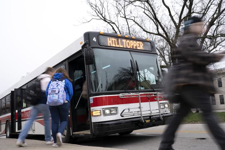 Students board the hilltopper line bus by Cherry Hall on WKU's campus.