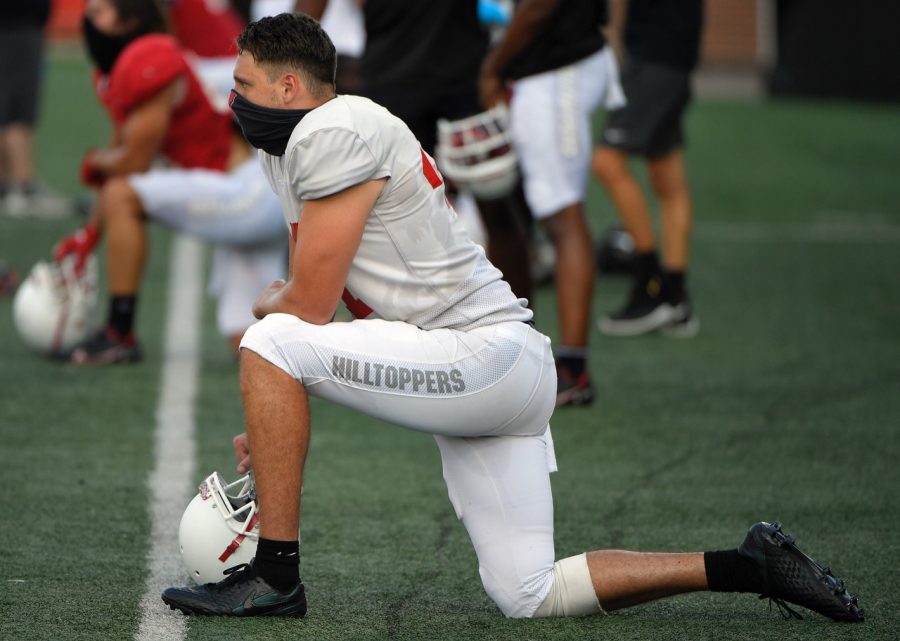 Punter John Haggerty kneels at practice in Houchens-Smith Stadium. The Sydney, Australia native enters into his senior year on The Hill. 