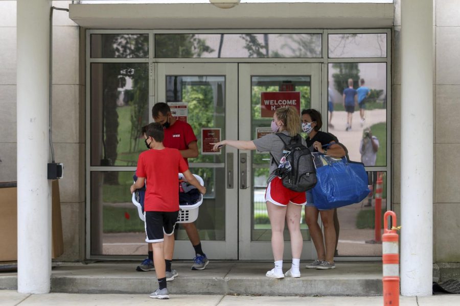 A student directs family members while moving into McCormack Hall on Wednesday, August 19, 2020.