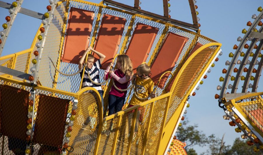 Three children look at each other while riding “Scat II” at Beech Bend Park on Sept. 19, 2020, the last day of the season.