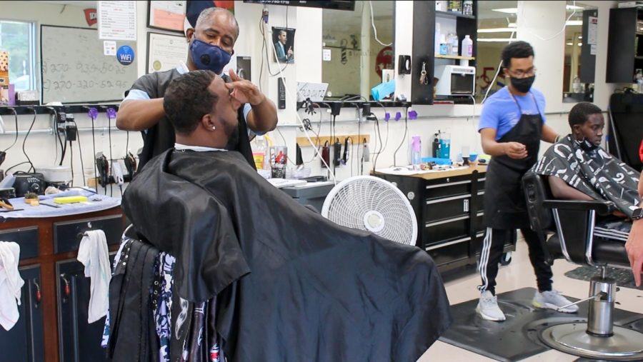 JC, Junius Carpenter, cuts a client’s hair at the shop his owns, Tuesday, September 22, 2020. He is thankful for the support of the community and loyal clients since the rise of COVID-19.