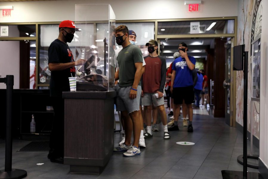 Students stand in line at the food court in Downing Student Union on August 27. After several days of long lines that go against social distancing guidelines, the food court at DSU has been updated with barriers and markers to keep students spaced apart.
