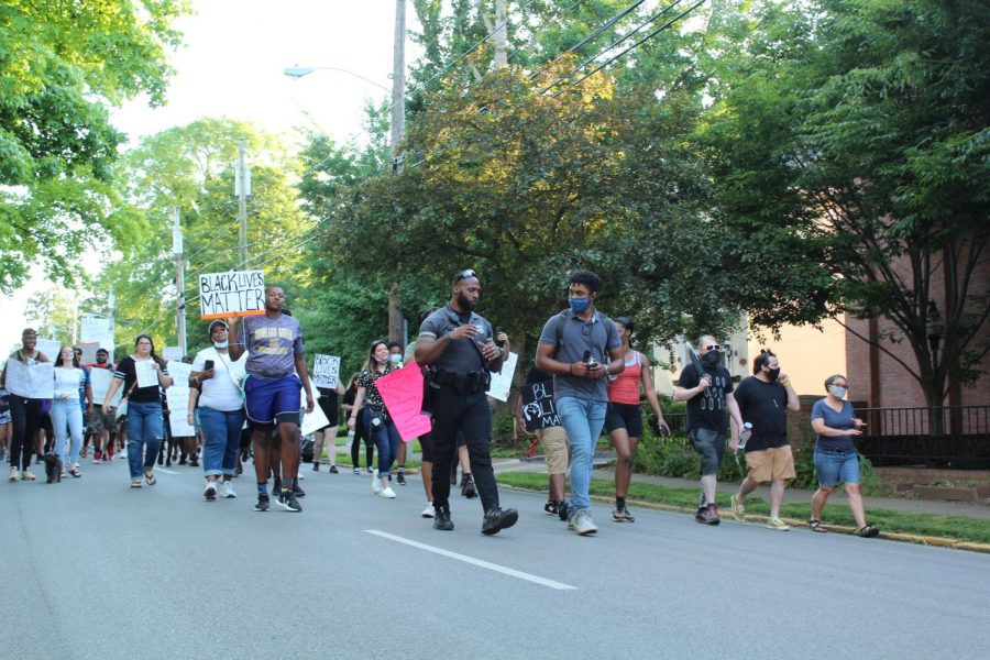 Officer Tim Gray of the WKU Police Department walking alongside protestors. 