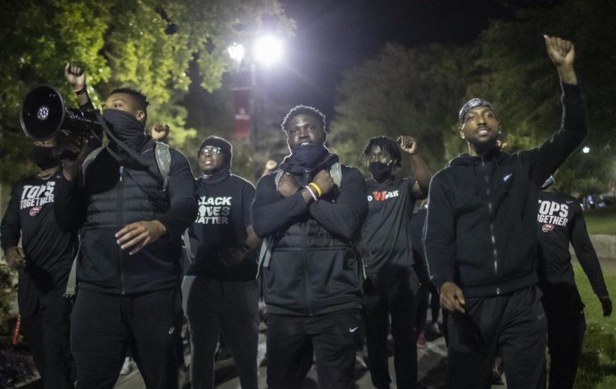 WKU athletes Juwan Jones, Demetrius Cain, and Tavion Hollingsworth lead protesters down Avenue of Champions during the Black Lives Matter protest organized by WKU Athletics on September 30, 2020.