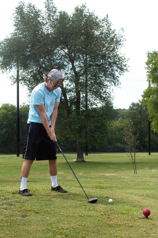 Attempting to perfect his form, Shelbyville senior Casey Warner waits until it feels just right to tee off while learning to golf at Hobson Golf Course.