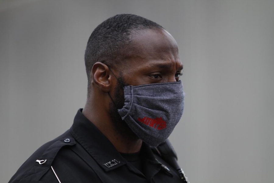 Tim Gray, an officer with the WKU Police Department, stands masked at the colonnade after the drive through ceremony that honored the graduates of the WKU Department of Communication graduates on May 16.