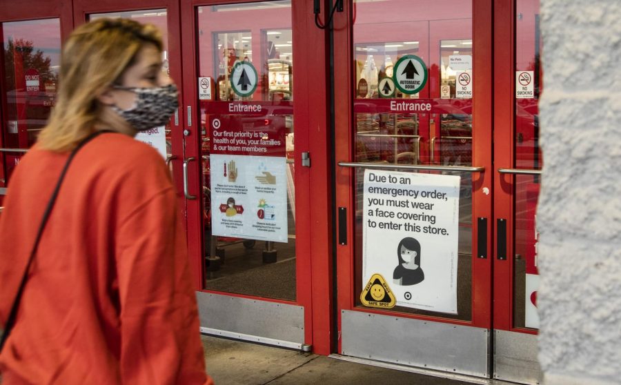 People walk into Target in Bowling Green, KY. Target is among the many other stores across Bowling Green that have put up signs informing customers to wear face coverings.