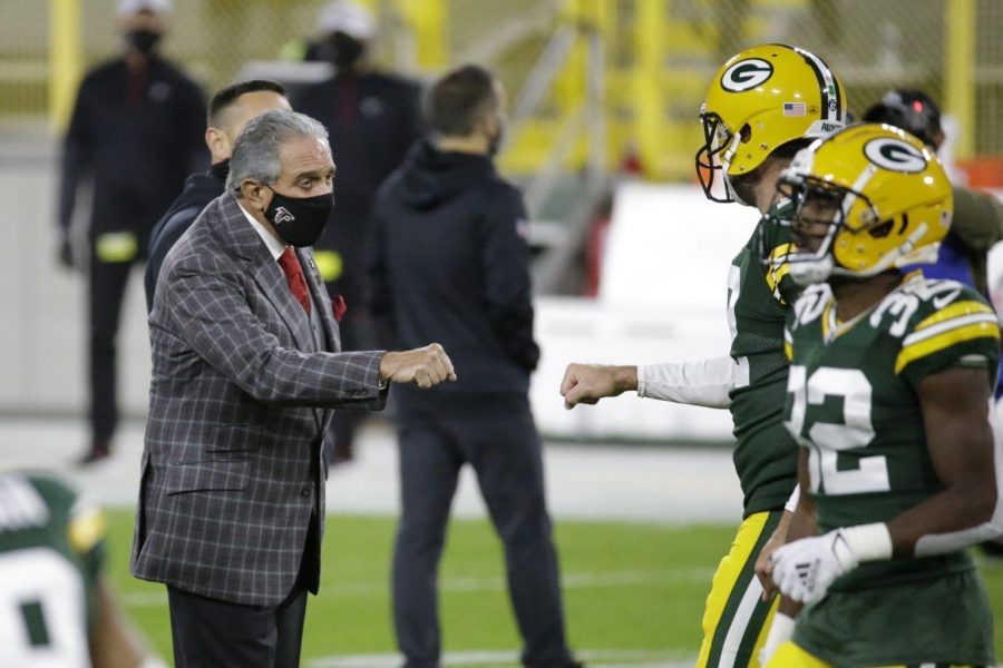 Atlanta Falcons owner Arthur Blank talks with Green Bay Packers quarterback Aaron Rodgers (12) before an NFL football game, Monday, Oct. 5, 2020, in Green Bay.