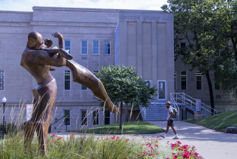 A student rushes past the “Trust” statue sculpted by Kendra Fleischman located on the top of Western Kentucky University’s campus on Monday morning, Aug. 31, 2020. Gordon Wilson Hall, the building behind the student, is home WKU’s Theater and Dance Program, who are currently dealing with the struggle of having to have classes in-person while still following COVID-19 guidelines.