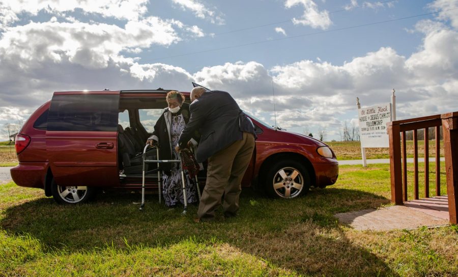 Pastor Clarence Tapp helps his mother, Dorothy Crowe, out of their car on Sunday morning before church service. Tapp has recently had to play a bigger role at the church. His mother, who usually splits the service with her son, suffered a stroke earlier this year in April and as such has had to take a step back during the recovery process.
