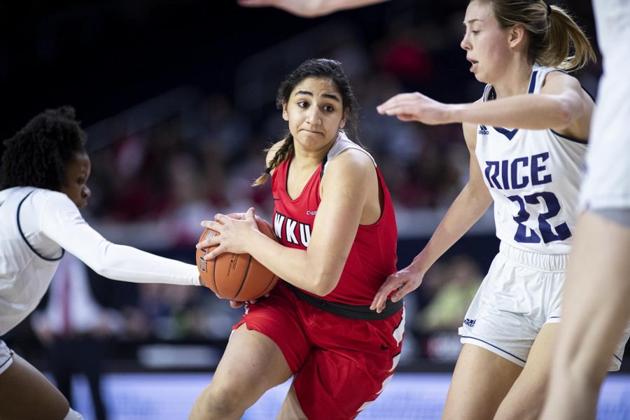 WKU freshman guard Meral Abdelgawad (30) drives into the paint against Nicole Iademarco (22) and a stingy Rice defense in the C-USA quarterfinal round at the Ford Center at The Star March 15 in Frisco, Texas. Abdelgawad only scored 5 points and had 3 rebounds in 21 minutes of play in the 64-57 loss. [HERALD/ Jospeh Barkoff]