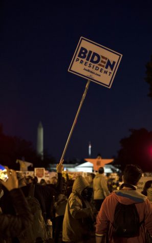 Protesters hold up signage for Presidential Candidate Joe Biden in the heart of the America’s capital, Washington, D.C., on the eve of election night, Nov. 3, 2020.