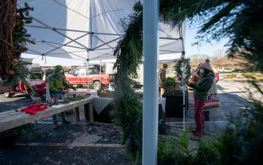 Alex and Rosie Hunt, owners of the Maple Yard, work at their booth at the Holiday Market at the BG Community Farmer’s Market on Dec. 5, 2020. They sold wreaths and Charisma Amaryllis, a bulb flower that blooms in the spring, there.