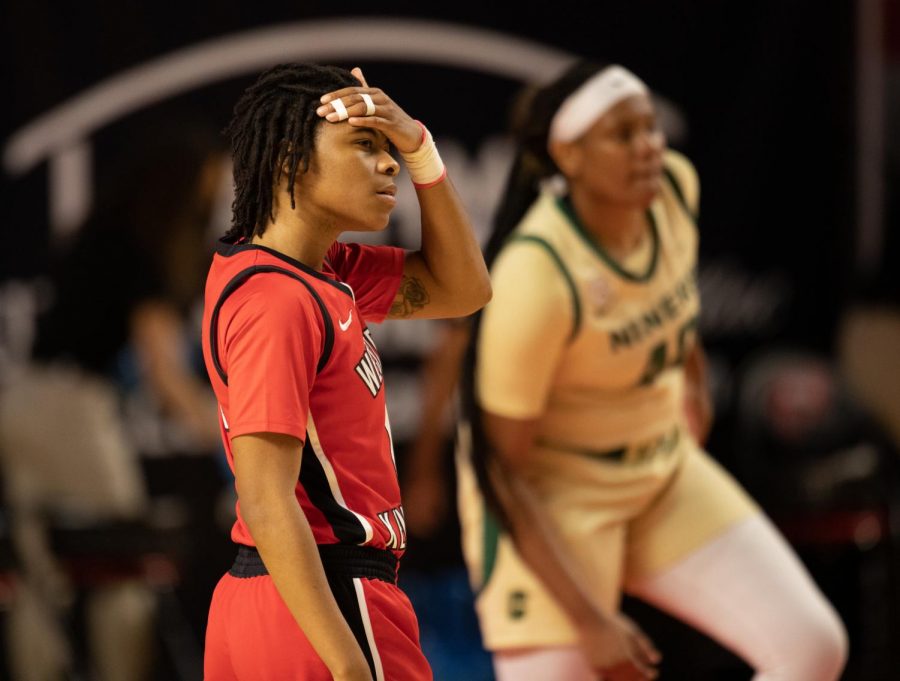 Lady Topper Myriah Haywood (00) wipes sweat from her head as she prepares for the next play.