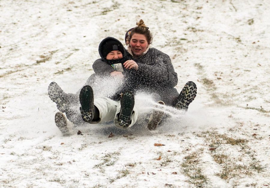 WKU students sled down the hill in front of Van Meter Hall on Feb. 15 after a snow and ice storm swept through Bowling Green leading WKU to cancel virtual and in-person classes.