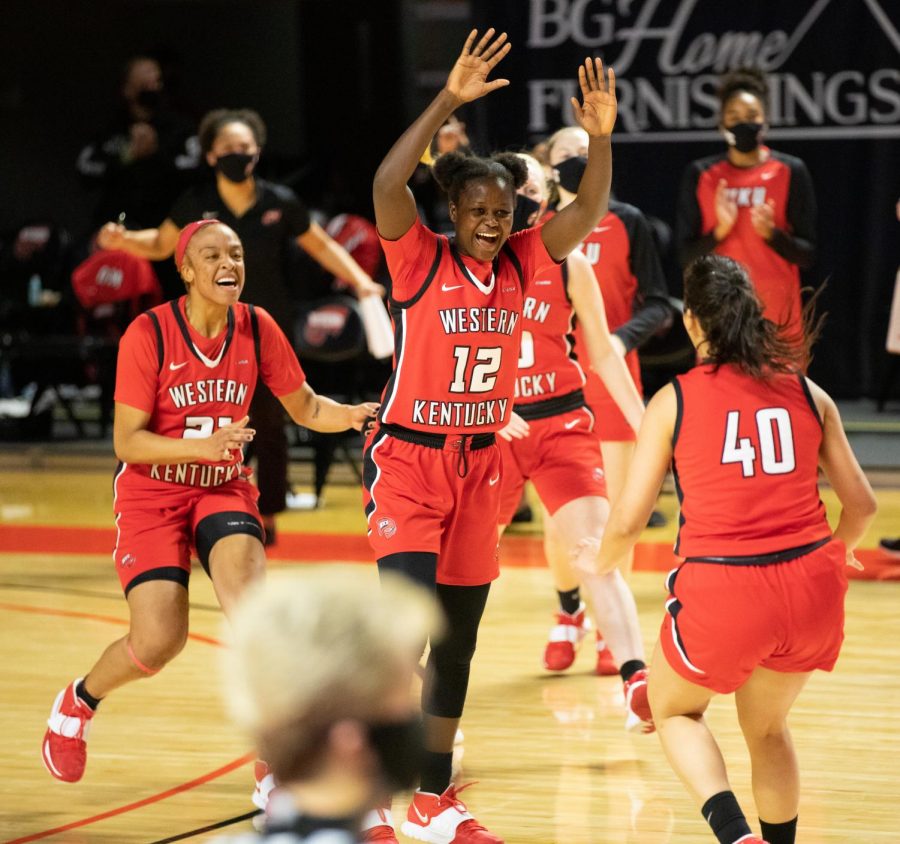 Western Kentucky University Lady Toppers celebrate their one point win over the Charlotte Lady 49ers: Tori Hunter (21), Fatou Pouye (12), Meral Abdelgawad (40).