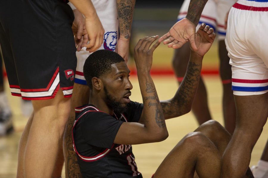 WKU Hilltopper guard senior Taveion Hollingsworth (11) accepts a opposing teammates help standing up during the game against the LA Tech Bulldogs on Jan. 9th, 2021 at E.A. Diddle Arena.