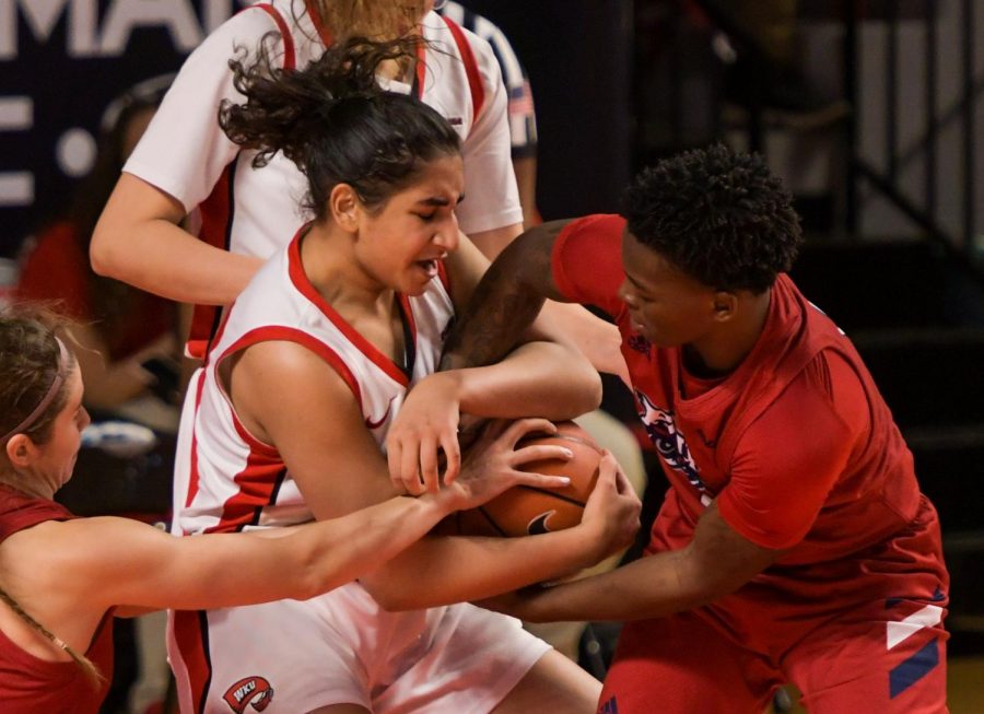 WKU guard Meral Abdelgawad (40) fights to hold onto the ball against FAU guard Iggy Allen (2) at the game at Diddle Arena on Feb. 5, 2021. WKU won 71-64.