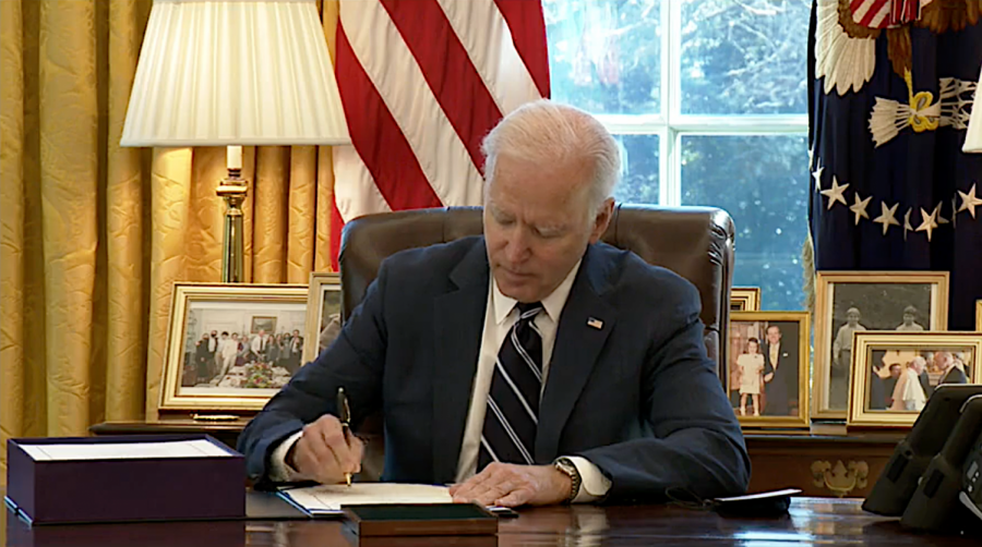 President+Joe+Biden+signs+the+American+Rescue+Plan+package+of+legislation+March+11%2C+2021%2C+at+in+the+Oval+Office+at+the+White+House.
