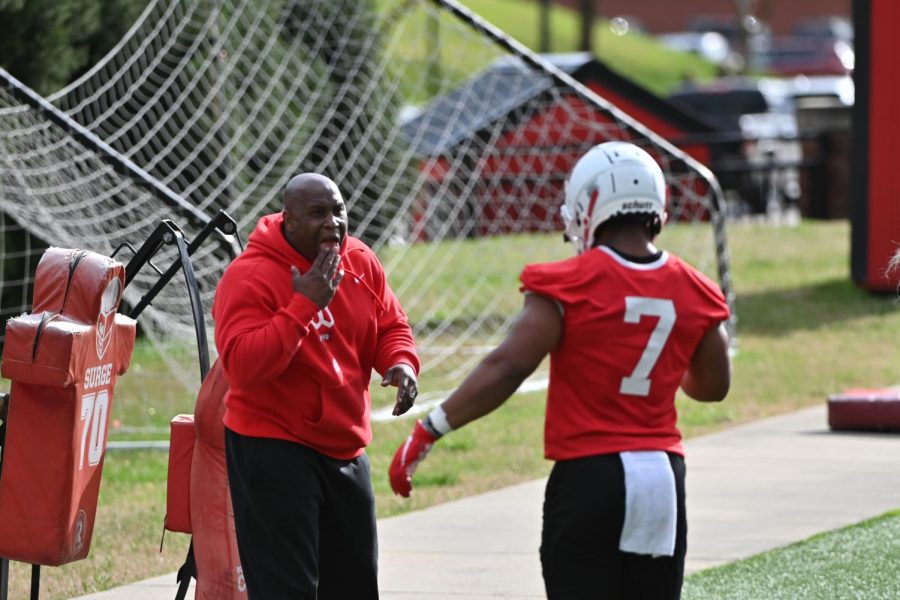 Running backs coach Carlos Locklyn talking to graduate running back Adam Cofield during WKUs second spring practice on March 18, 2021. 