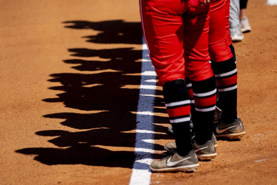 WKU softball players stand on the foul line during the national anthem before the game against UAB Saturday, March 20, 2021.