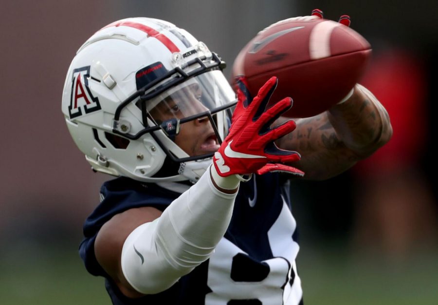 Receiver Stanley Berryhill III stretches out to try to haul in a a throw as the University of Arizona continues with their spring season, Tucson, Ariz., March 25, 2021.