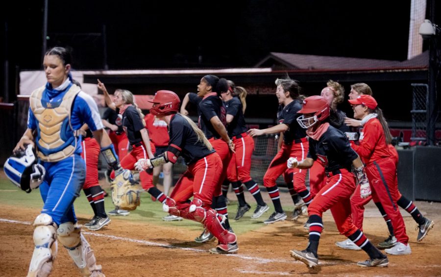 WKU celebrates after beating No. 7 Kentucky on a walk-off hit by redshirt senior Kennedy Sullivan (4) on Wednesday, March 24, 2021.