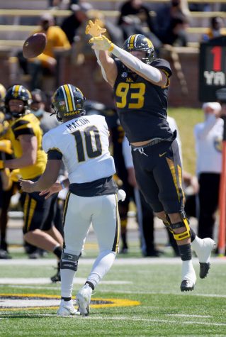 Quarterback Tyler Macon, left, throws the ball past rushing defender Andrew Serrano on Saturday at Faurot Field. Macon is a freshman who previously played at East St. Louis.