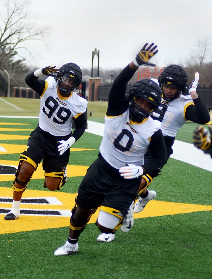 Defensive+lineman+Isaiah+McGuire%2C+left%2C+and+Akial+Byers%2C+center%2C+run+a+drill+at+spring+practice+Feb.+26+at+the+Mizzou+Athletics+Training+Complex+in+Columbia.+McGuire+will+play+as+a+full-time+defensive+end+this+season+after+previously+splitting+time+at+defensive+tackle+and+defensive+end.